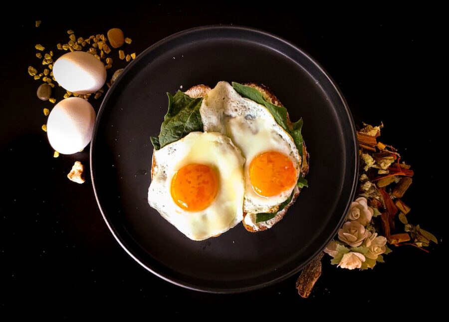 sunny side up egg on black ceramic plate. eggs can help you to increase dopamine level