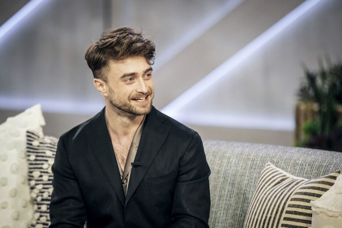 daniel radcliffe smiling in tv show while talking about his net worth 2023